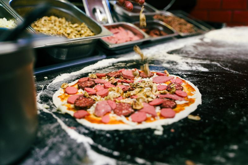 Chef preparing dewey's pizza in the open kitchen view